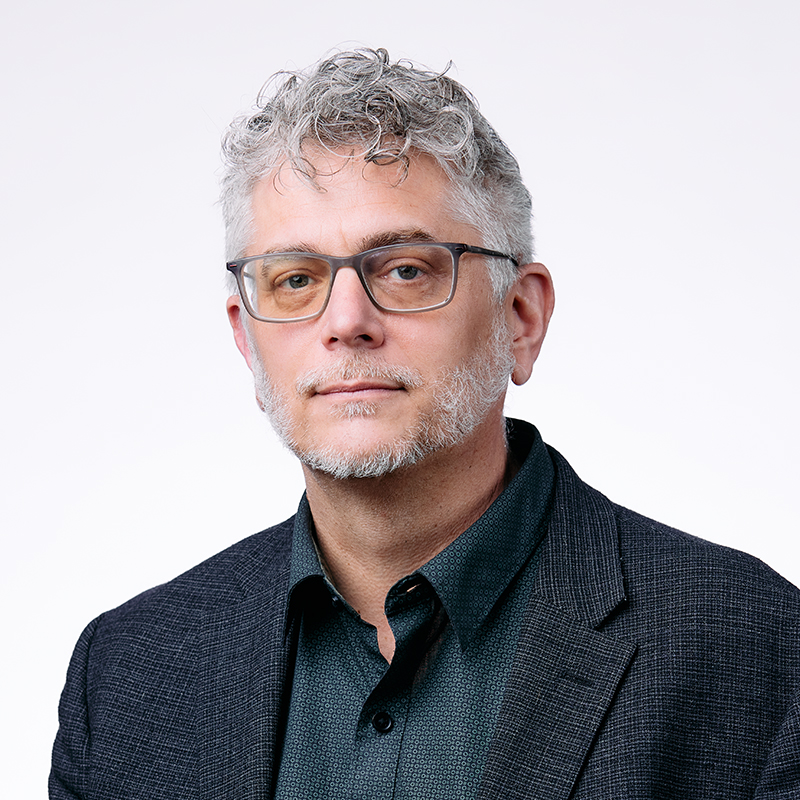 Dean Bianco has silver hair and glasses