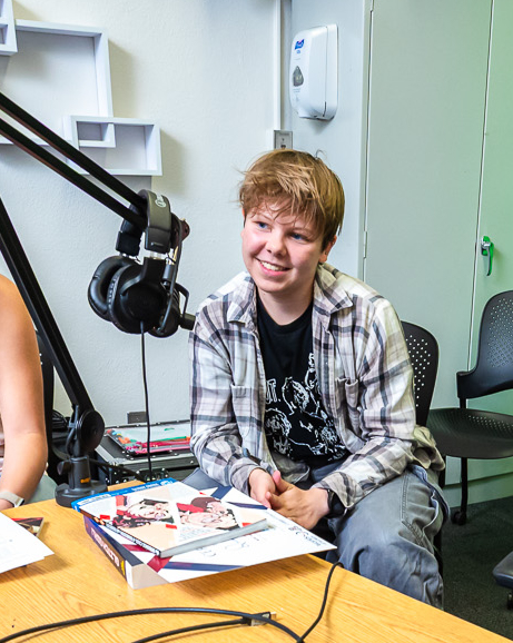 teen boy talks into a microphone