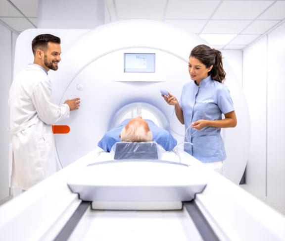 A woman being prepared for an MRI scan