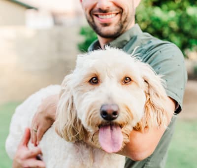 Close up of a man holding a dog