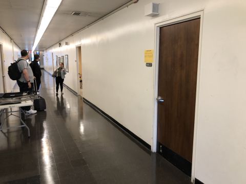 Tiara, Tantek, and David stand in a long hallway outside room E314.