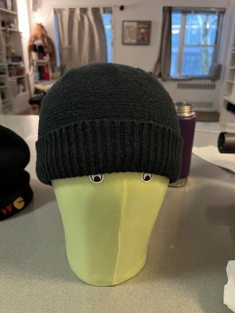 Front view of the Black Chattie on the pale green mannequin. From this angle you can see small stickers give the mannequin eyes.