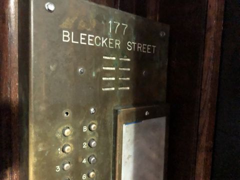 a call box for 177 Bleecker Street. the label for button A has been worn down.