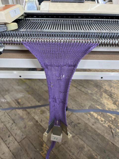 The purple swatch continues to grow, now with signs of practice with lace, picking up previously stitched rows to form a hem, and increasing stitches.