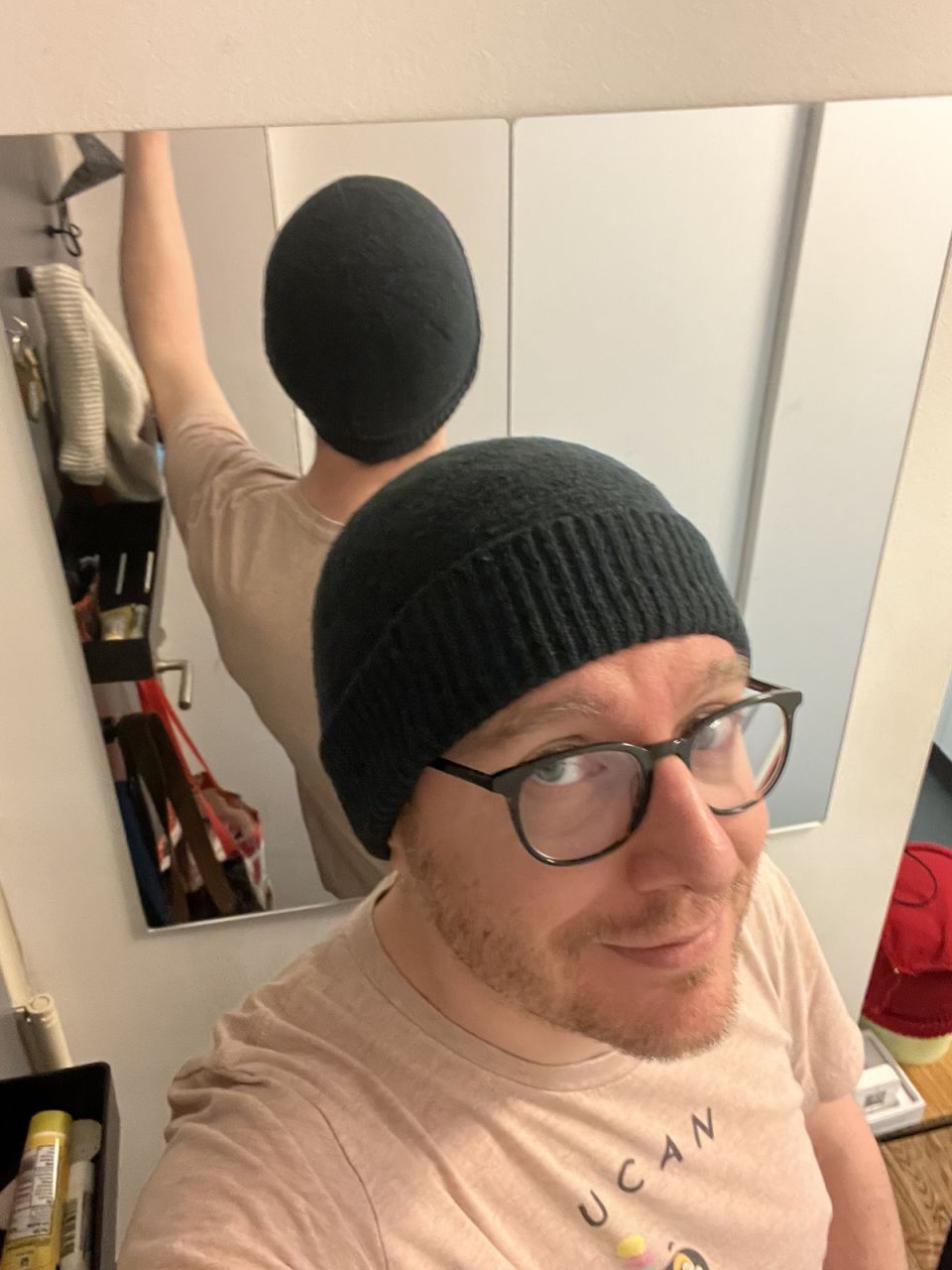 Posing with the hat in a mirror again, to make the front and back of it visible. It sits snugly on my head.