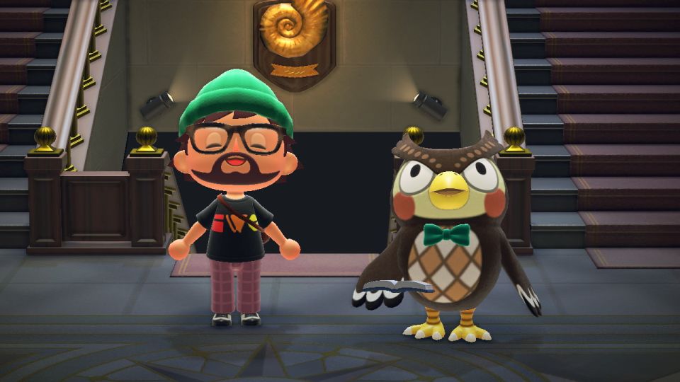 Marty's character in Animal Crossing wearing an IndieWebCamp t-shirt smiles while standing next to Blathers the owl.