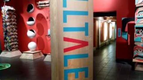In a well lit art gallery, Modern Totem Poles are displayed.