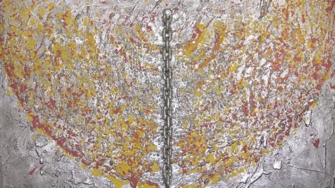 A gray wall with a half circle of paint and a chain
