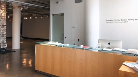A reception desk in the lobby of a company.
