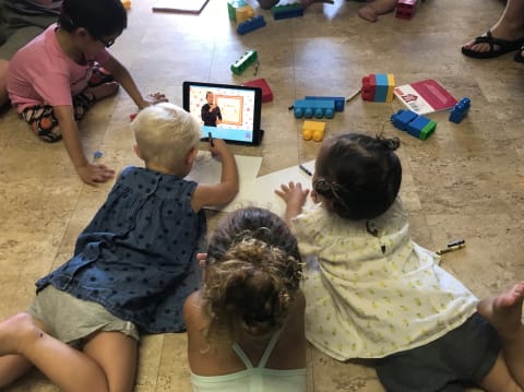 Deaf children watch an educational sign language video made by Motion Light Lab.