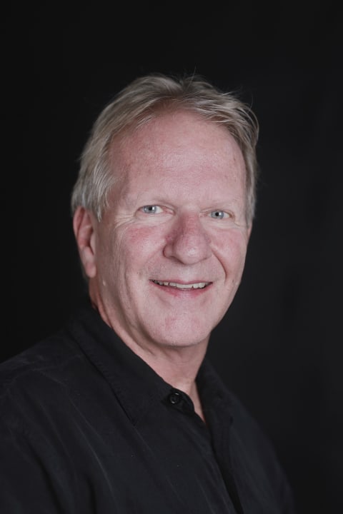 A headshot-style photograph of a man.