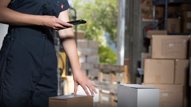 women scanning boxes