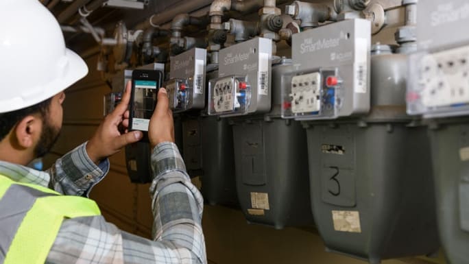 worker scanning gas meter