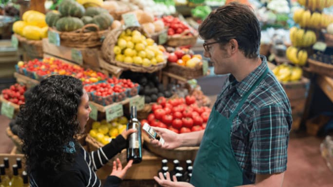 woman asking product details from worker