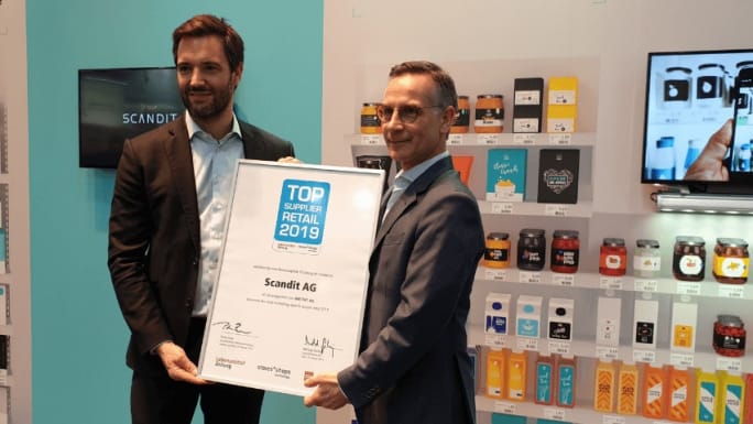 two men holding a prize