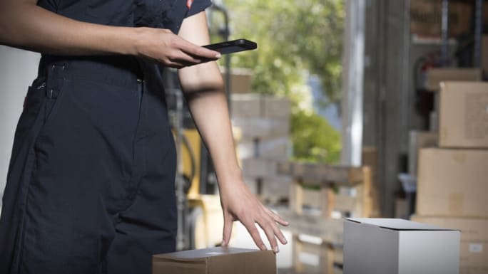Delivery man scanning package label