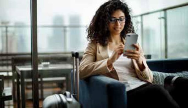 smiling woman navigating on phone
