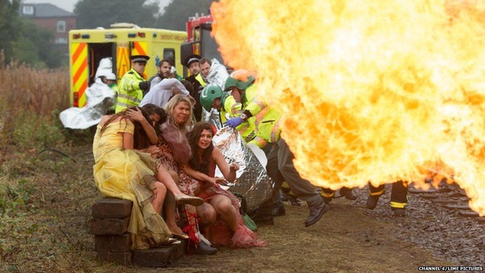 In a scene from Hollyoaks, a train explodes while paramedics tend to the wounded