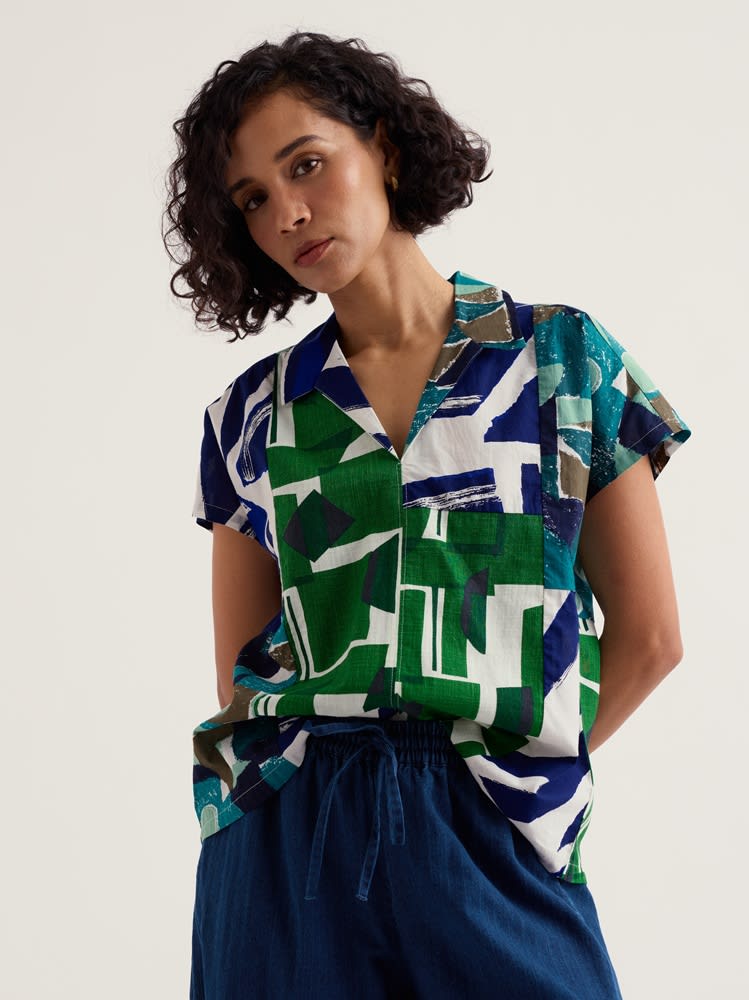 Model wearing patchwork Deep Lane Top in green and blue fabrics cut from SS25 end-of-roll designs
