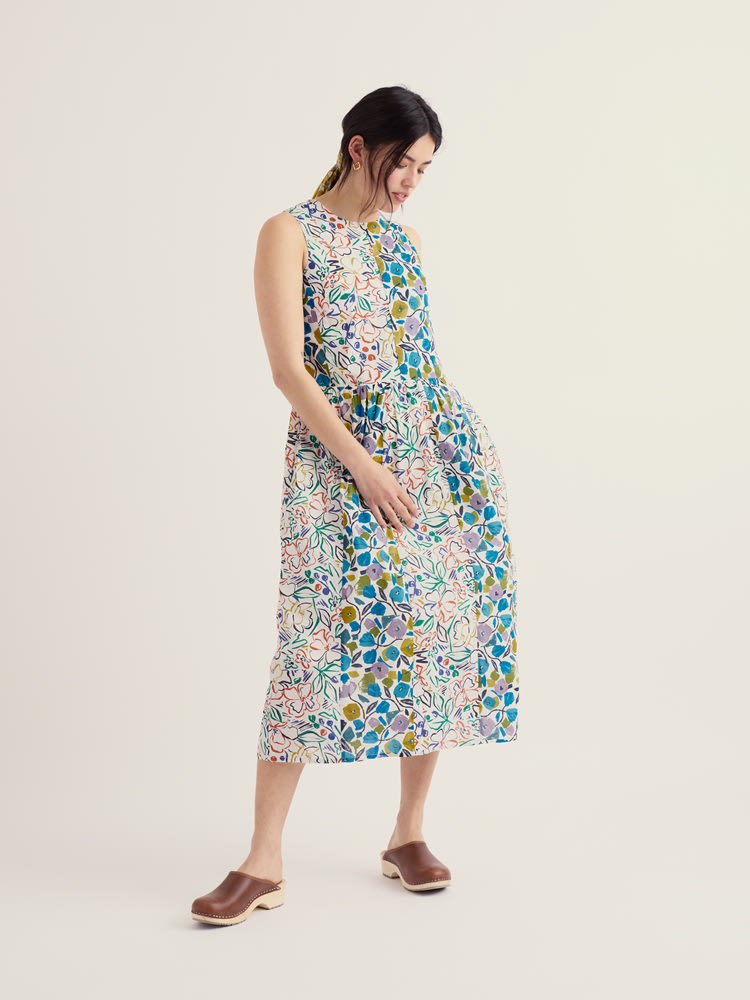 Model in studio wearing midi dress made from green and blue patchwork of floral prints