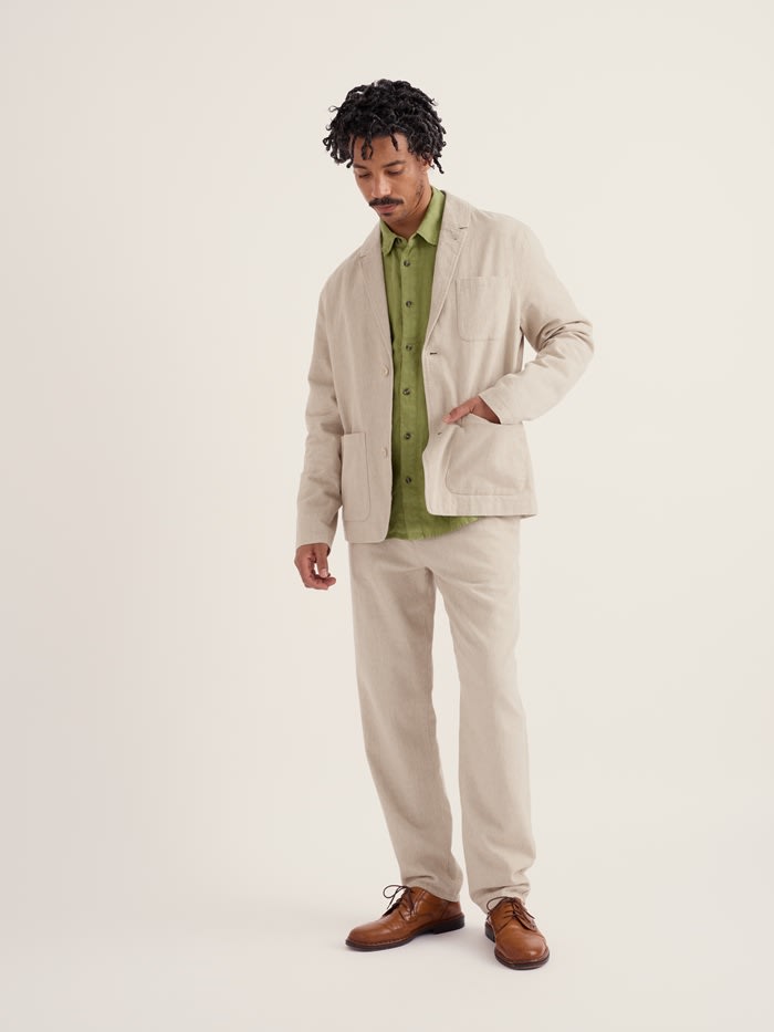 A male model in our Men's Messack Jacket with a matching linen trouser.