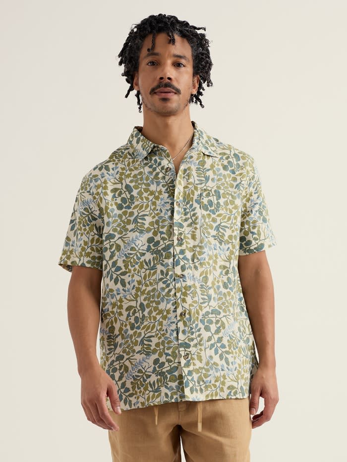 A male model wearing our Men's Blue Heron Short Sleeve Shirt in a tonal foliage print.