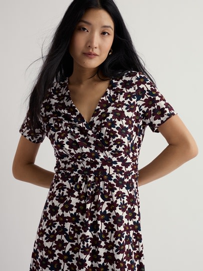 A model wearing our Chapelle Dress in Inked Cosmos Chalk, a floral print.