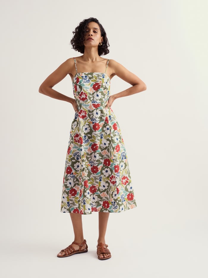 A model wearing a floral midi dress.