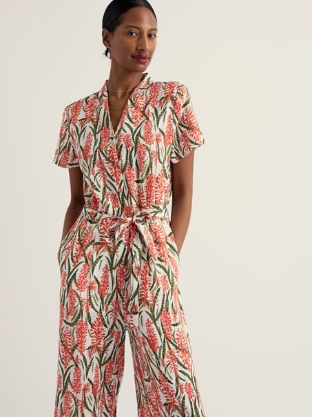 A model wearing our Treen Cove Jumpsuit in Red Hot Poker Chalk.