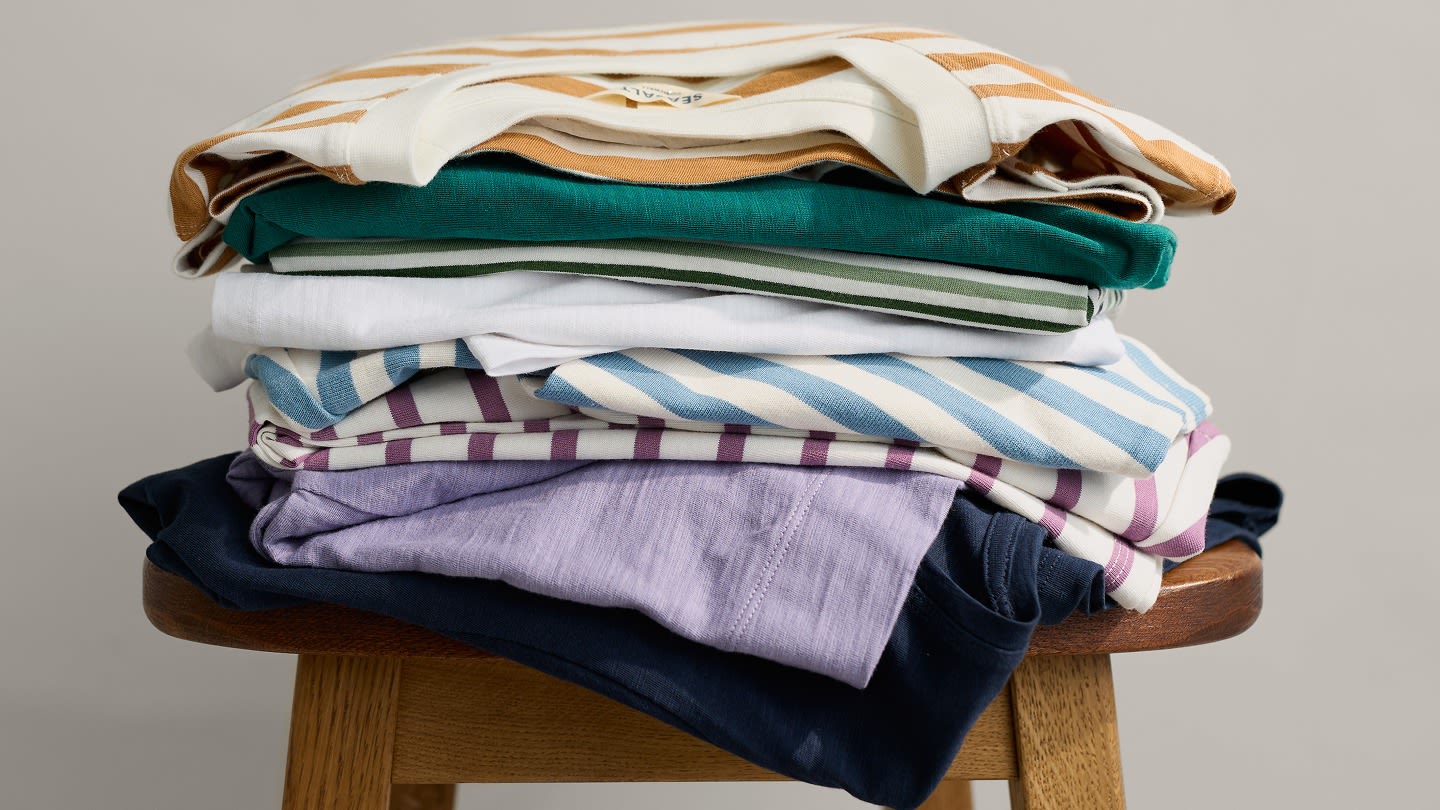 A stack of cotton Seasalt t-shirts in varying colours and stripe patterns.