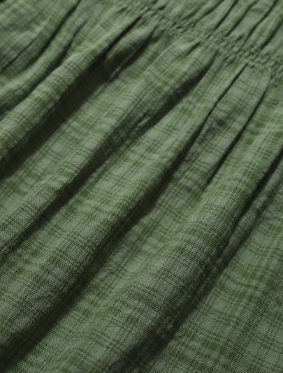 A close up of dark green woven organic cotton fabric