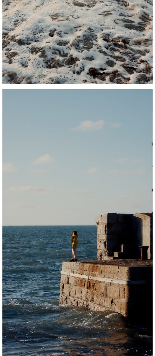 An image of the sea next to an image of Fiona Curtis wearing a yellow coat and looking out to the horizon from a Cornish habour.