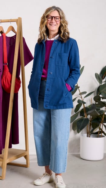 Laura Watson styling Seasalt's latest collection Laura Watson styling a denim jacket from Seasalt's latest collection while standing next to a rail of clothes