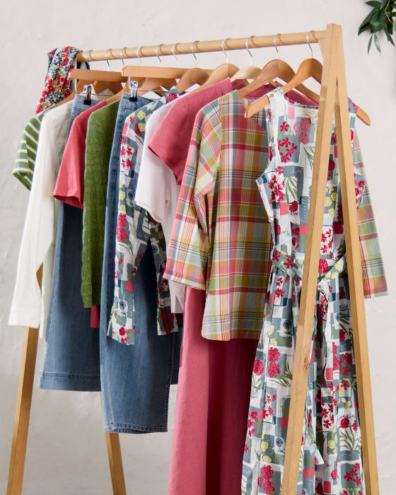 A rail of clothes from Seasalt's spring collection in shades of pastel pink and green
