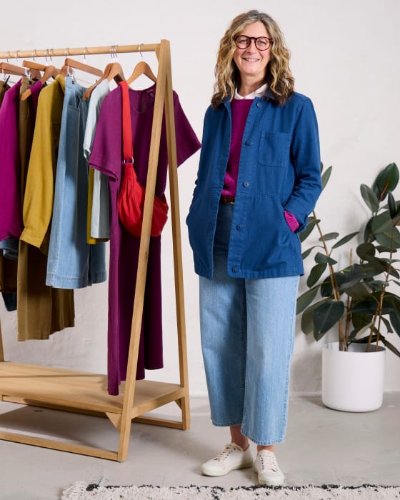 Laura Watson styling Seasalt's latest collection Laura Watson styling a denim jacket from Seasalt's latest collection while standing next to a rail of clothes