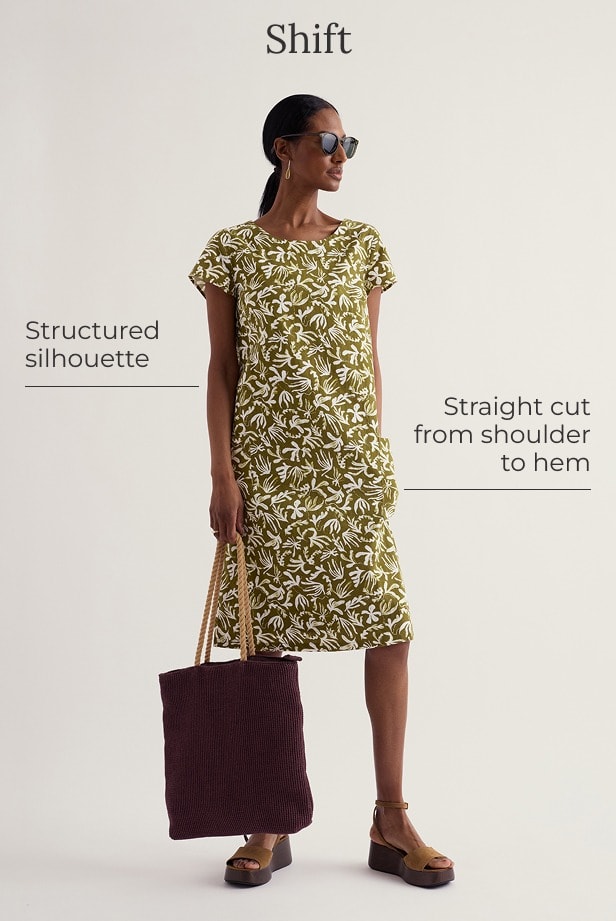 A model wears a green mini knee length shift dress with a white floral pattern