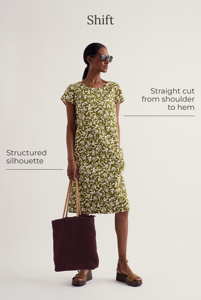 A model wears a green mini knee length shift dress with a white floral pattern