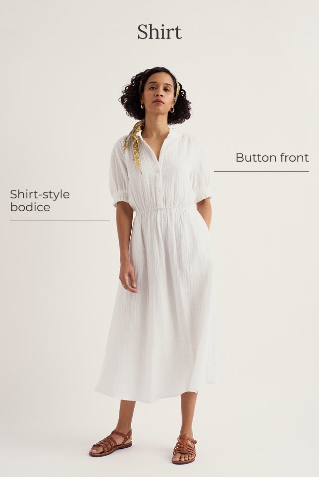 A model wears a white shirt dress with a yellow hair scarf