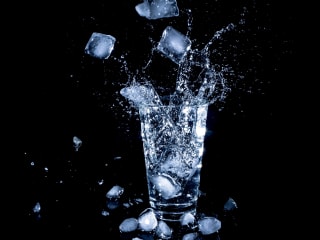 Seawalker Tech image of ice tumbling into a glass of water..
