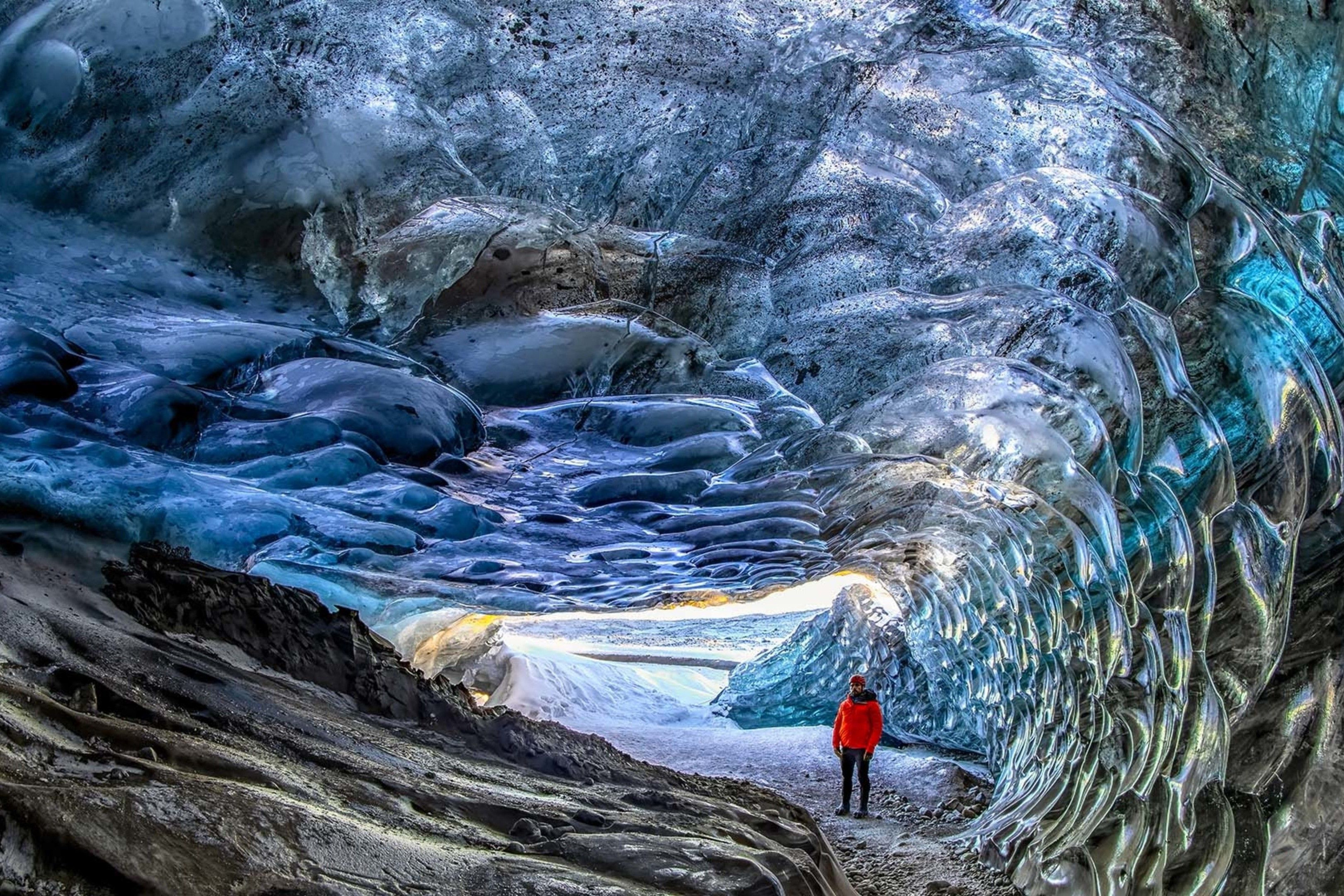 man visiting crystal ice cave in glacier1