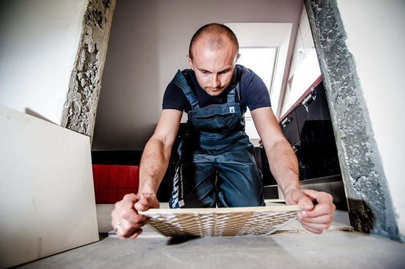 Contractor installing tiles