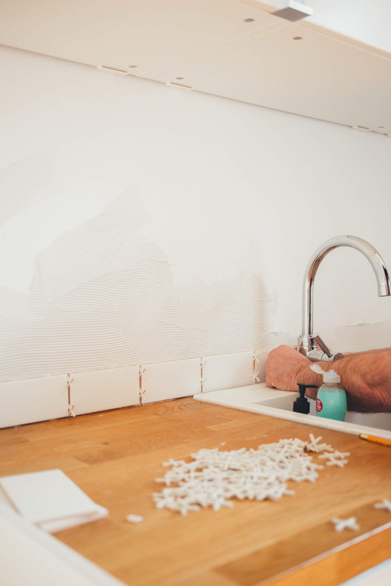 white tile installation in a kitchen