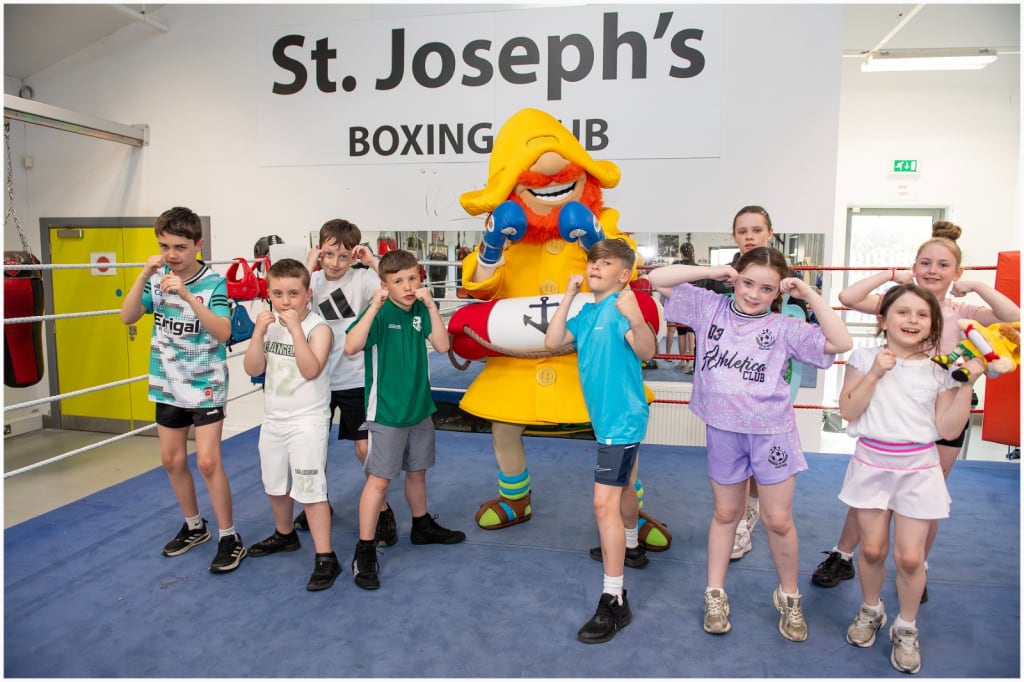 Charity photo of the CompareNI Fisherman Rod mascot and young boxers from a local boxing club.