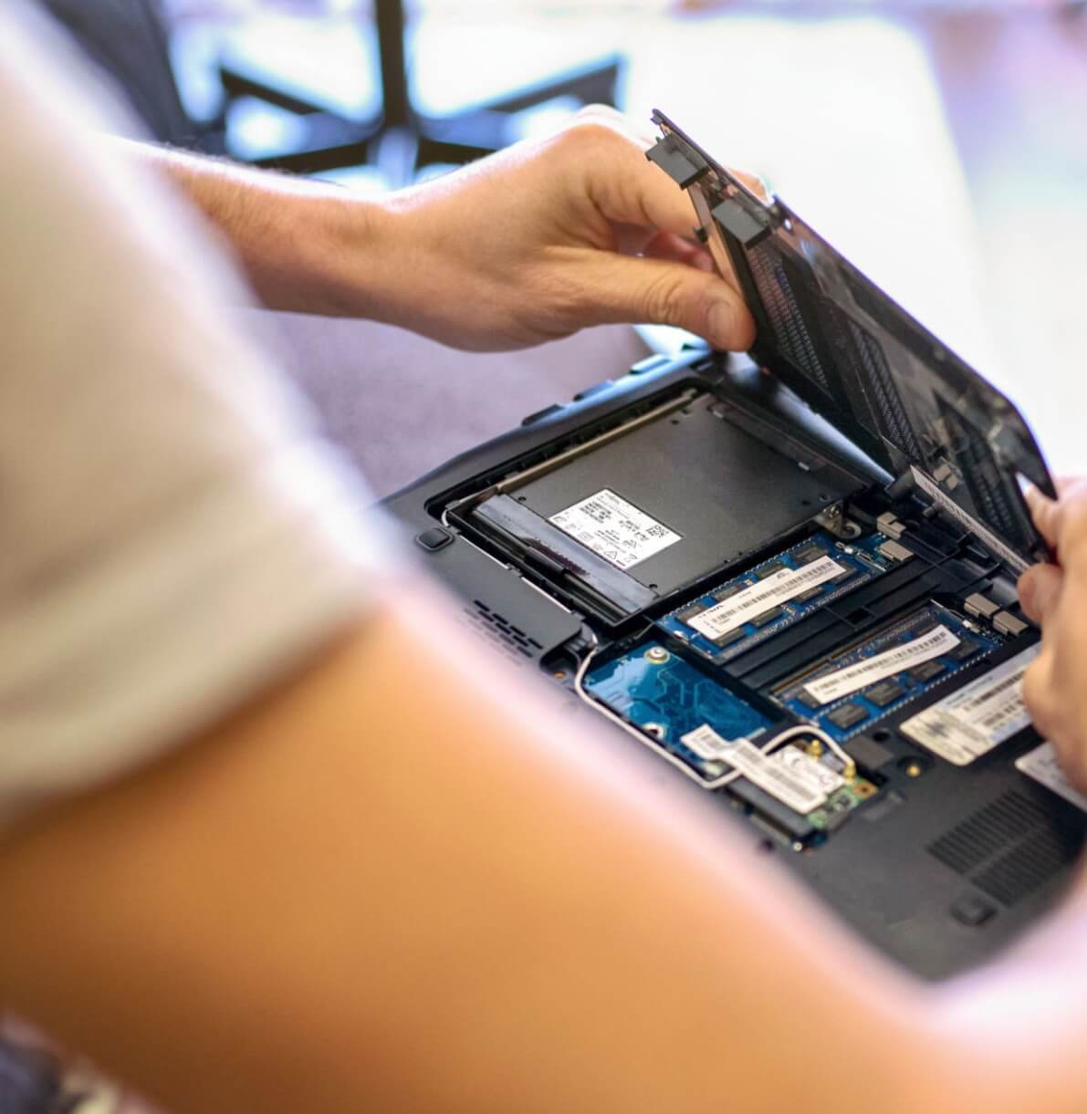 Technician repairing a laptop at Vuma Computers in Benoni