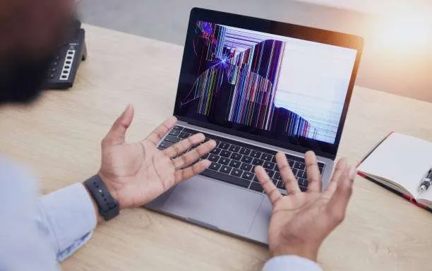 Man with a cracked laptop screen