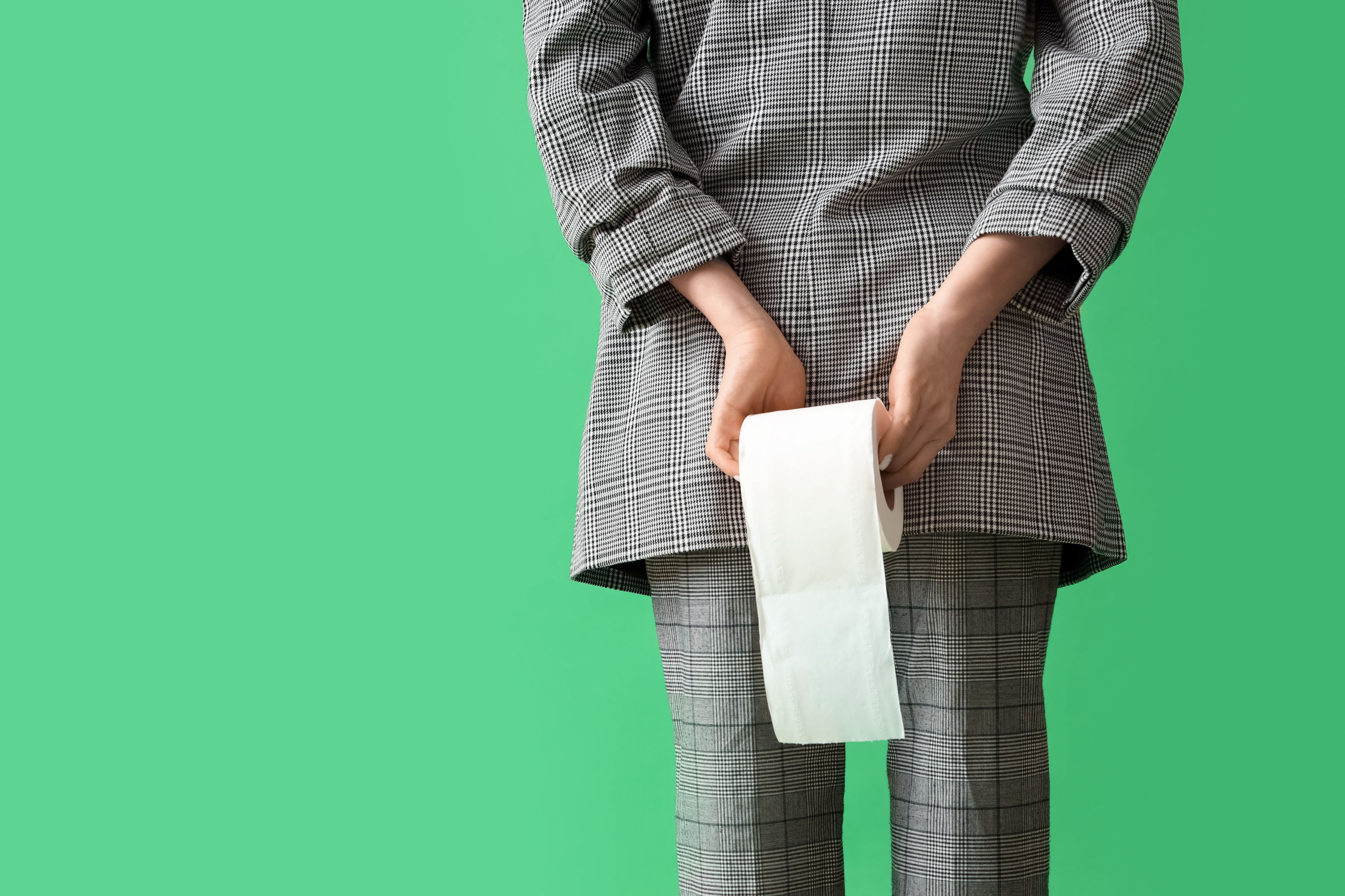 worker holding toilet paper