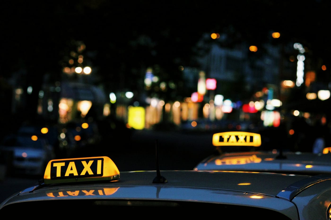 “Taxis at night in Budapest with the city in the background” by Lexi Ruskell on Unsplash