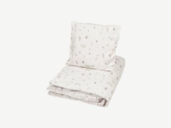 White bedding with small animals printed.