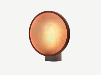 Table lamp with elliptical base and a disc-shaped top.