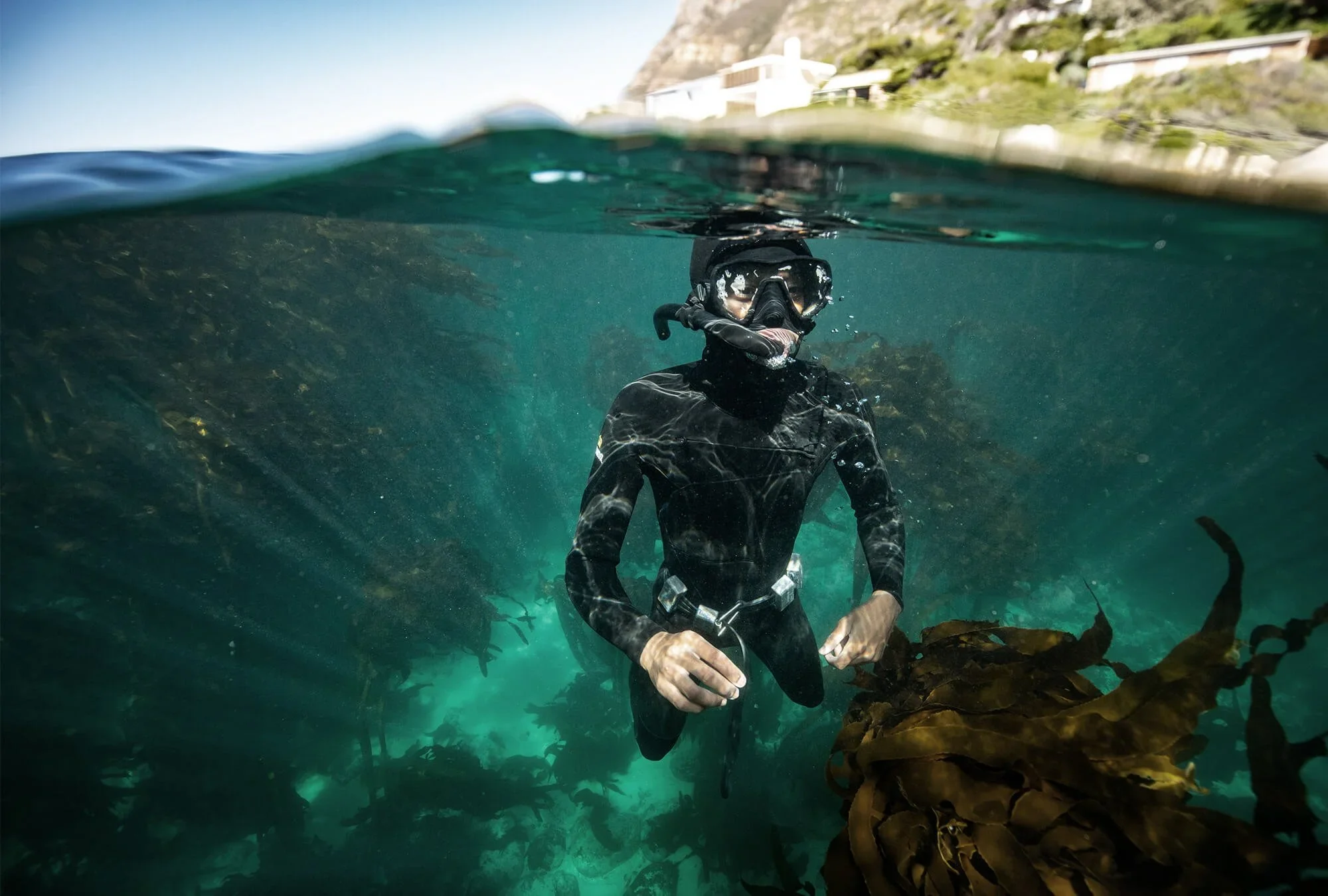 Loyiso Dunga submersed within the Wild Coast. 
- Photography by Sacha Specker